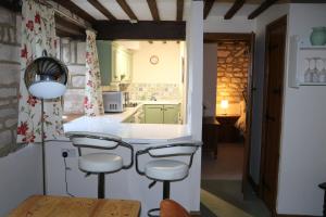 a kitchen with a counter and stools in a room at Flat 1 - The Old Mill - Bowbridge Lock - Stroud in Stroud