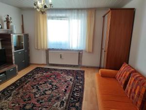 a living room with a couch and a window at Apartment Hernals in Vienna