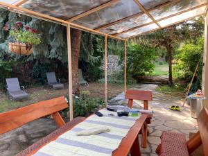 a patio with a table and chairs and a pergola at Kisvölgy House in Eger