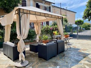 a pavilion with a table and chairs under it at Casa nel Golfo - free parking in Rapallo