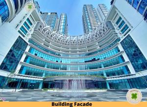 a large building with a fountain in front of it at Pacific Tower Petaling Jaya By Shamrock in Petaling Jaya