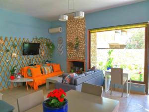 a living room with a couch and a fireplace at Seaside mountain view Golden Mar villa in Paránimfoi