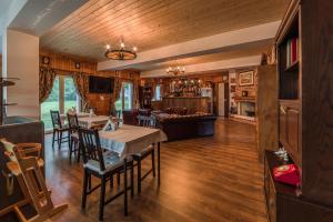 a dining room and living room with a table and chairs at Mountain View Lodge in Ranintsi