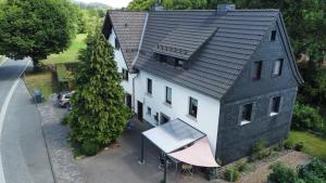 an overhead view of a house with a tennis court in front of it at Fewo Lindenhof in Hatzfeld