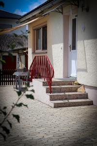 a red stair railing in front of a house at Ferienhaus Schneckenheisl in Mindelstetten