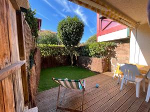 a patio with two chairs and a table on a deck at Splendide appartement de charme avec patio, parking et plage à 3 minutes in Biarritz