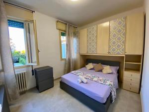 a small bedroom with a bed and a window at Venice -Mestre Rooms in Mestre