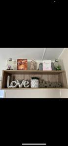 a wooden shelf with some items on it at Yogi's Space in Birchington