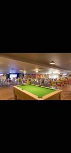 a large green pool table in a room at Yogi's Space in Birchington