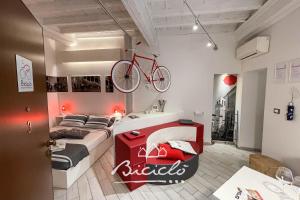 a bedroom with a bed with a bike on the wall at Biciclo' Rosso Ferrara in Ferrara