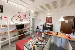 a living room with a bike hanging on the wall at Biciclo' Rosso Ferrara in Ferrara