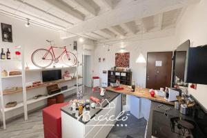 a room with a desk and a bike on the wall at Biciclo' Rosso Ferrara in Ferrara