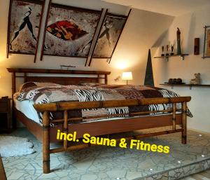 a bedroom with a wooden bed in a room at Ferienwohnung Fitness Entspannung Sauna im Westerwald in Derschen