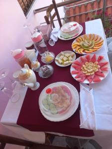 a table with plates of food and drinks on it at Guest House Bumbli in Berat