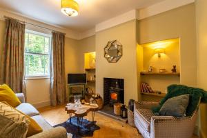 a living room with a couch and a fireplace at Cosy cottage in the heart of Bakewell in Bakewell