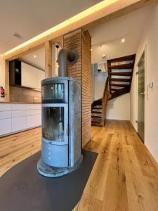 a kitchen with a woodburning stove in the middle of a room at Ferienhaus Fuchseck in Bad Liebenzell +20 photos