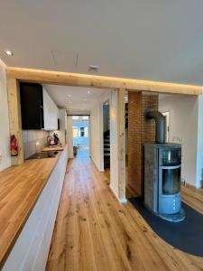 a kitchen and living room with a woodburning stove at Ferienhaus Fuchseck in Bad Liebenzell