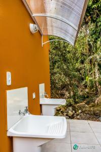 a bathroom with a sink and a toilet at Chalés da Libélula in Ilhabela