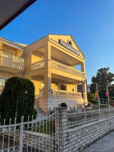 a building with a fence in front of it at Philoxenia Inn in Limenas