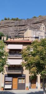 a building with a mountain in the background at Casas Natura - Centro Graus in Graus