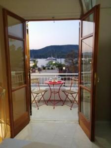 a view of a balcony with a table and chairs at Waterway view in Galatas