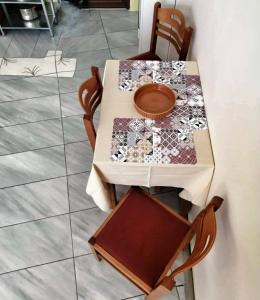 a table with two chairs and a table with a plate on it at Waterway view in Galatas +21 photos