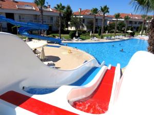 a slide in a pool at a resort at TALYA TURİZM TATİLEVLERİ ve VİLLALARI in Belek