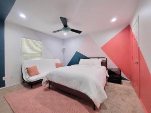 a bedroom with a bed and a ceiling fan at Rack'em Up 6 beds Pool Table GRB Downtown in Houston