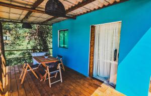 a room with a table and chairs on a deck at Flat Noronha Dreams in Fernando de Noronha