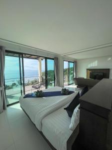 a bedroom with two beds and a view of the ocean at High Life Villas in Salad Beach