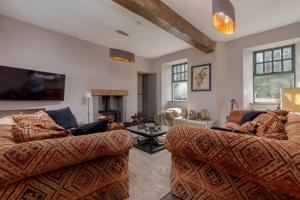 a living room with two couches and a table at Rachel's Farm luxury escapes with Hots Tubs in Buchlyvie