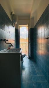 a bathroom with a sink and a tub and a window at Oasi Home in Sulmona