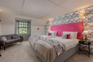 a bedroom with two beds and a pink headboard at Rachel's Farm luxury escapes with Hots Tubs in Buchlyvie