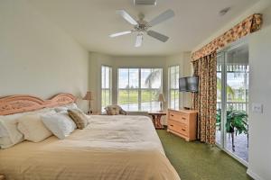 a bedroom with a bed and a ceiling fan at Naples Condo with Golf View and Resort-Style Amenities in Naples