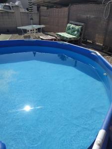 une grande piscine bleue avec une chaise et une table dans l'établissement EBREHOME, à Deltebre