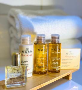 four bottles of essential oils sitting on a shelf at Hôtel Les Vieilles Tours Rocamadour in Rocamadour