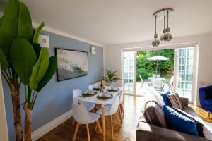 a living room with a table and a couch at Riverwalk Apartment One in Datchet