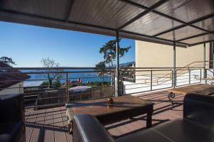a balcony with a table and a view of the ocean at Apartments Villa Dinka in Opatija