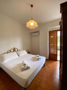 a bedroom with a white bed with towels on it at Casa Uliveto in Mattinata +66 photos