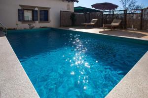 a swimming pool with blue water in a backyard at Apartments Villa Dinka in Opatija