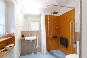 a bathroom with a shower and a sink at Gasthof zum weissen Rössli in Erschwil