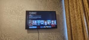 a flat screen tv hanging on a wall at LONDON ROOM 1 in London