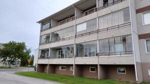an apartment building with balconies on the side of it at Herostreet Apartment 9 in Iisalmi
