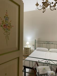 a bedroom with a bed and a table and chairs at Affittacamere Bellavista in San Marco dei Cavoti