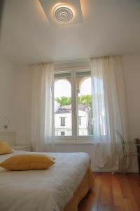 a bedroom with a bed and a large window at Locanda Mezzosale in Conegliano