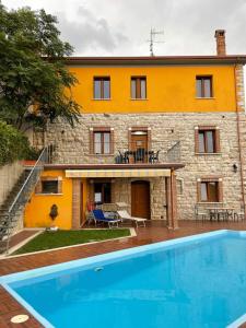 a house with a swimming pool in front of it at Affittacamere Bellavista in San Marco dei Cavoti