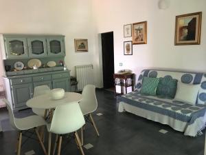 a living room with a bed and a table and chairs at PODERE 31 in Santa Margherita di Pula