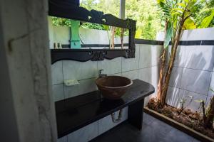 a bathroom with a bowl sink and a mirror at Fond Doux Eco Resort in Soufrière