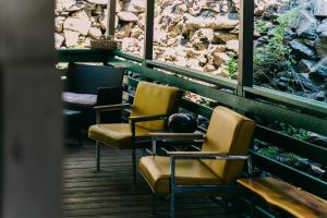 a row of chairs sitting on a porch at Battle Creek Lodge in Keystone