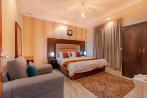 una camera d'albergo con letto e divano di شقق البحر الازرق المخدومة a Qal'at Bishah